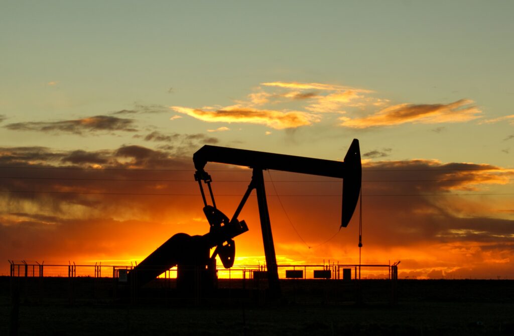 pexels-photo-16862261-16862261 Dramatic silhouette of an oil pump jack against a vibrant sunset sky, emphasizing energy extraction.