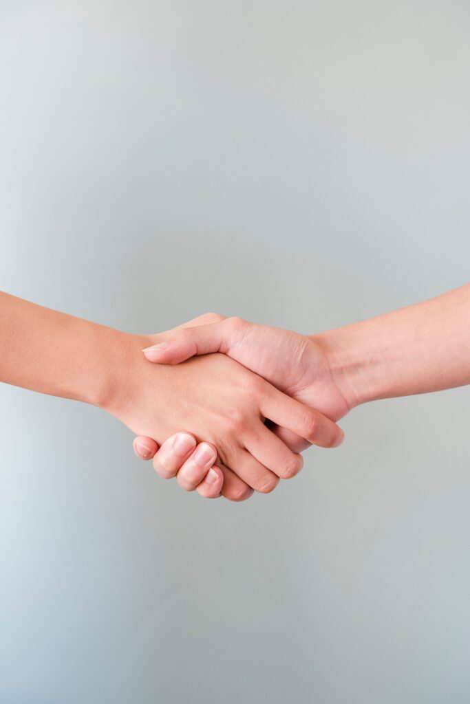 pexels-photo-9017746-9017746 A detailed view of a handshake between two individuals, symbolizing agreement and collaboration.